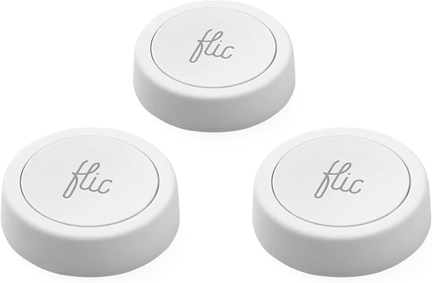 Three Flic smart buttons in different colors on a white surface, showing compact round design with adhesive backing