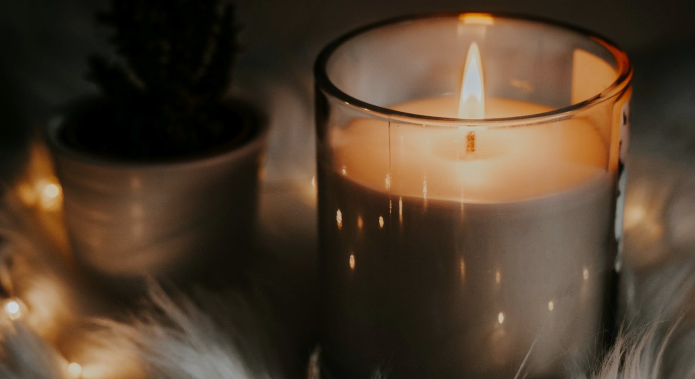 Dim room vignette suggesting open-flame candle mess and residual wax worry on a nightstand